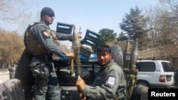 Afghan policemen arrive at the site of a blast in Kabul, March 21, 2018.