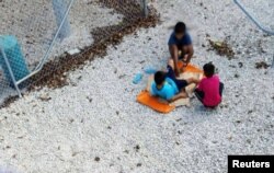An undated supplied image from Amnesty International claiming to show children playing near a fence at the country's Australian-run detention centre on the Pacific island nation of Nauru.