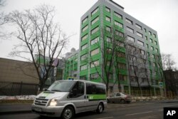 FILE - In this file photo taken Oct. 27, 2017, a car of Russian state-owned television station RT passes by the company's office in Moscow.