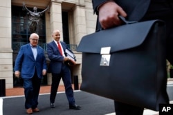 Jay Nanavati, second from left, one of the lawyers for former Donald Trump campaign chairman Paul Manafort, leaves federal court after attending the Manafort trial in Alexandria, Virginia, Aug. 7, 2018.