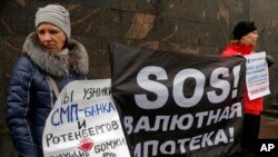 FILE - Hard-currency mortgage holders take part in a protest in front of a bank in St. Petersburg, Russia, Jan. 28, 2016. Many Russians have begun to feel the impact of sanctions imposed on Moscow following its annexation of Ukraine's Crimea.