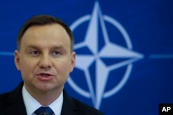 Polish President Andrzej Duda briefs the media, Nov. 28, 2016, after a joint visit with German President Joachim Gauck. On Wednesday, Dec. 14, 2016, Duda was urged to veto a freedom of assembly bill by human rights groups.