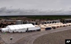 FILE - This undated photo provided by the Department of Health and Human Services' Administration for Children and Families shows the shelter used to house unaccompanied immigrant children in Tornillo, Texas.