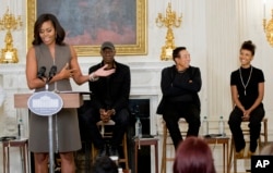 From left, first lady Michelle Obama introduces Grammy award-winning blues musician Keb’ Mo’, singer-songwriter Smokey Robinson and jazz musician Esperanza Spalding at the White House in Washington, Oct. 14, 2015.