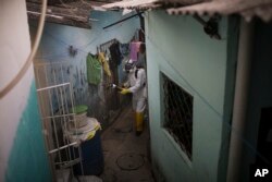 A municipal worker sprays insecticide to combat the Aedes aegypti mosquitoes that transmits the Zika virus, at the Imbiribeira neighborhood in Recife, Pernambuco state, Brazil, Jan. 26, 2016.