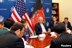 FILE - U.S. special envoy for peace in Afghanistan, Zalmay Khalilzad, center, speaks during a roundtable discussion with Afghan media at the U.S. Embassy in Kabul, Afghanistan, Jan. 28, 2019.