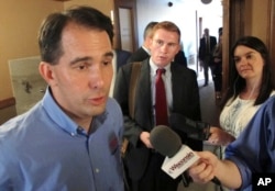 FILE - Wisconsin Gov. Scott Walker speaks to the media Tuesday, Aug. 1, 2017, in Madison, Wis.