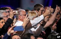 Supporters cheer and photograph President Donald Trump as he speaks at the Conservative Political Action Conference, Feb. 24, 2017.