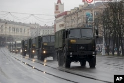 Police vehicles drive through a street during an opposition rally in Minsk, Belarus, March 25, 2017. A cordon of club-wielding police blocked the demonstrators' movement along Minsk's main avenue near the Academy of Science. Hulking police detention trucks were deployed in the city center.