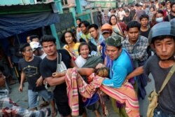 Myanmar, Mandalay, People pull out Shell Ye Win 24 who was shot during the security force crack down on anti-coup protesters