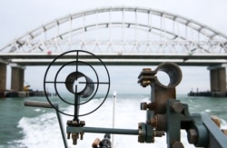 A patrol boat of the coast guard of the Border Service under Russia's Federal Security Service approaches the Kerch Strait Bridge, on December 5, 2018.