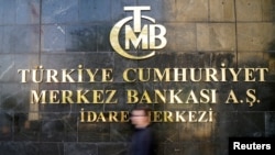 FILE - A man passes by Turkey's central bank headquarters in Ankara, Turkey, April 19, 2015.