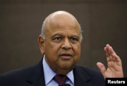 FILE - South African Finance Minister Pravin Gordhan gestures during a media briefing in Sandton near Johannesburg March 14, 2016.