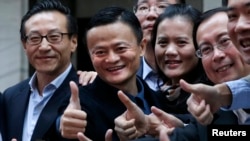 Alibaba Group Holding Ltd founder Jack Ma (2nd L) poses as he arrives at the New York Stock Exchange for his company's initial public offering (IPO) under the ticker "BABA" in New York Sept. 19, 2014.