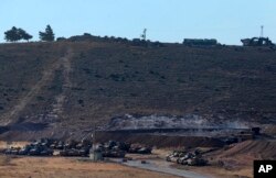 Turkey's tanks and vehicles hold positions close to the border with Syria, Oct. 9, 2017. Turkey's military said Monday that Turkish troops moved into Syria's northwestern Idlib province as part of an operation to enforce an internationally agreed upon de-escalation zone.