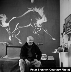 Tyrus Wong at his home in California in 2004. Behind him is a mural of a horse he painted in 1955. Photo © Peter Brenner.