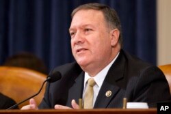 FILE - House Benghazi Committee member Rep. Mike Pompeo, R-Kan., questions Democratic presidential candidate Hillary Clinton, during the committee's hearing on Capitol Hill in Washington.