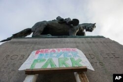 A sign saying Heather Heyer Park is placed at the base of the statue of Confederate Gen. Robert E. Lee in Emancipation Park in Charlottesville, Va., Aug. 18, 2017. Heyer was killed while protesting a white nationalist rally in Charlottesville Aug. 12.