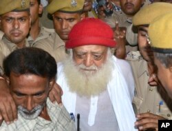 Asaram Bapu, a controversial spiritual guru who was arrested on Sept.1 on a rape charge filed by a teenage girl is brought to a hospital for a medical check up in Jodhpur, India, Sept. 9, 2013.