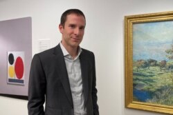 Scott Lynn, CEO and founder of Masterworks, poses next to artworks in New York, U.S., February 11, 2020.