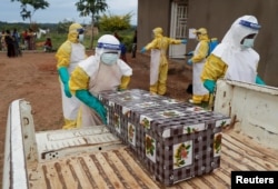 FILE - Healthcare workers carry the coffin of a baby believed to have died of Ebola, in Beni, North Kivu Province of Democratic Republic of Congo, Dec. 15, 2018.