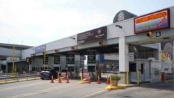Vehicles pay a toll at the Detroit-Windsor tunnel in Detroit, Aug. 9, 2021. Canada recently lifted its prohibition on Americans crossing the border to shop, vacation or visit.