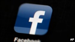 FILE - In this May 16, 2012, file photo, the Facebook logo is displayed on an iPad in Philadelphia. Facebook is under fire for failing to rein in fake and biased news stories that some believe may have swayed the presidential election. Its predicament stems from this basic conundrum: It exercises great control over the news its users see, but it declines to assume the editorial responsibility that traditional publishers do. (AP Photo/Matt Rourke, File)