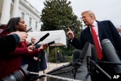FILE - President Donald Trump takes question from reporters on the South Lawn of the White House, in Washington, Nov. 9, 2018. Trump has dismissed concerns about how Whitaker will deal with the ongoing Russia investigation.