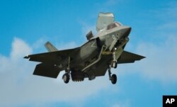 FILE - The F-35 Lightning II hovers in front of crowds at the Farnborough Air Show in the United Kingdom, July 12, 2016.