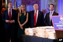 President-elect Donald Trump, accompanied by his family, arrives a news conference in the lobby of Trump Tower in New York, Jan. 11, 2017.