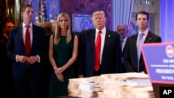 President-elect Donald Trump, accompanied by his family, arrives a news conference in the lobby of Trump Tower in New York, Jan. 11, 2017.