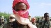 Recently trained Shebab fighters stand during military exercise in northern Mogadishu’s Suqaholaha neighborhood (Jan 2010 file photo)