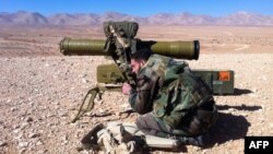 A pro regime soldier aims a rocket launcher towards rebel locations in the Qalamoun region on the outskirts of the Syrian capital Damascus on February 13, 2014. 