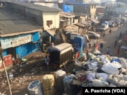 A street along Mumbai's Dharavi slum in India is littered with waste that includes plastic items and bags.