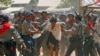 Police are seen hitting a student demonstrator during a crackdown on protests in Letpadan March 10, 2015.