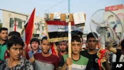 FILE - Thousands of Iraqis braved the scorching summer heat to stage the protest against government corruption in Tahrir Square in Baghdad, Aug. 7, 2015.