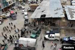 Rescue workers and army soldiers gather at the site of a blast at a vegetable market in Quetta, Pakistan, April 12, 2019.