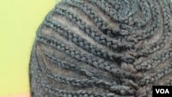 Some customers prefer natural hairstyles like corn rows or an afro, May 16, 2014 (Gillian Parker for VOA).
