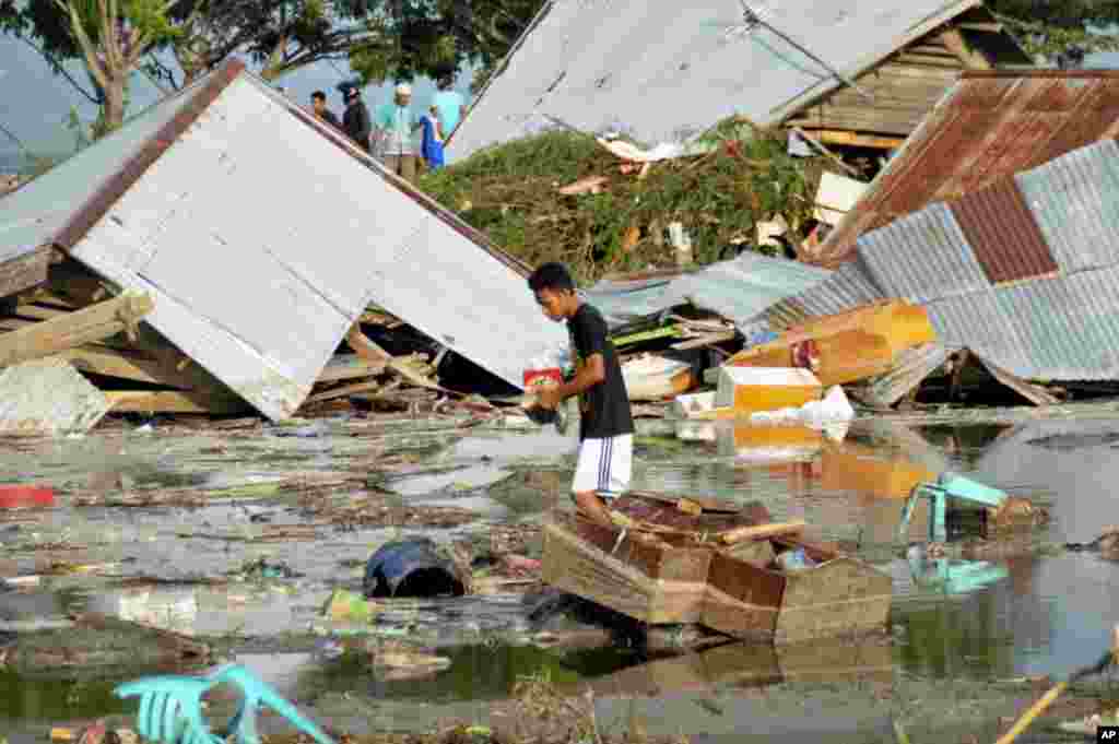 A man surveys the damage caused by earthquake and tsunami in Palu, Central Sulawesi, Indonesia,, Sept. 29, 2018. 