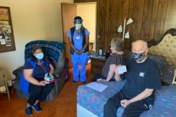 John McFarland (70), menunjukkan kartu vaksinasi setelah menerima vaksinasi COVID-19 di dalam kamar tidurnya di Hayward, California, 6 Mei 2021.