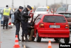 FILE - French police conduct a control at the French-German border in Strasbourg, France, to check vehicles and verify the identity of travelers as security increases after last Friday's deadly attacks in Paris, Nov. 20, 2015.