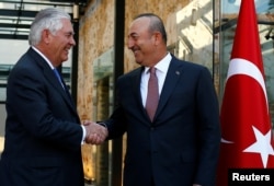 FILE - U.S. Secretary of State Rex Tillerson, left, meets with Turkish Foreign Minister Mevlut Cavusoglu in Istanbul, Turkey, July 9, 2017.