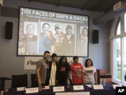 FILE - Filmmakers, from left, Sergio Arau and Yareli Arizmendi, and immigrants Carolina Moran, Julio Basurto and Juana Garcia launch a photo exhibition in Washington June 6, 2016, about families that would be covered under an immigration executive action.
