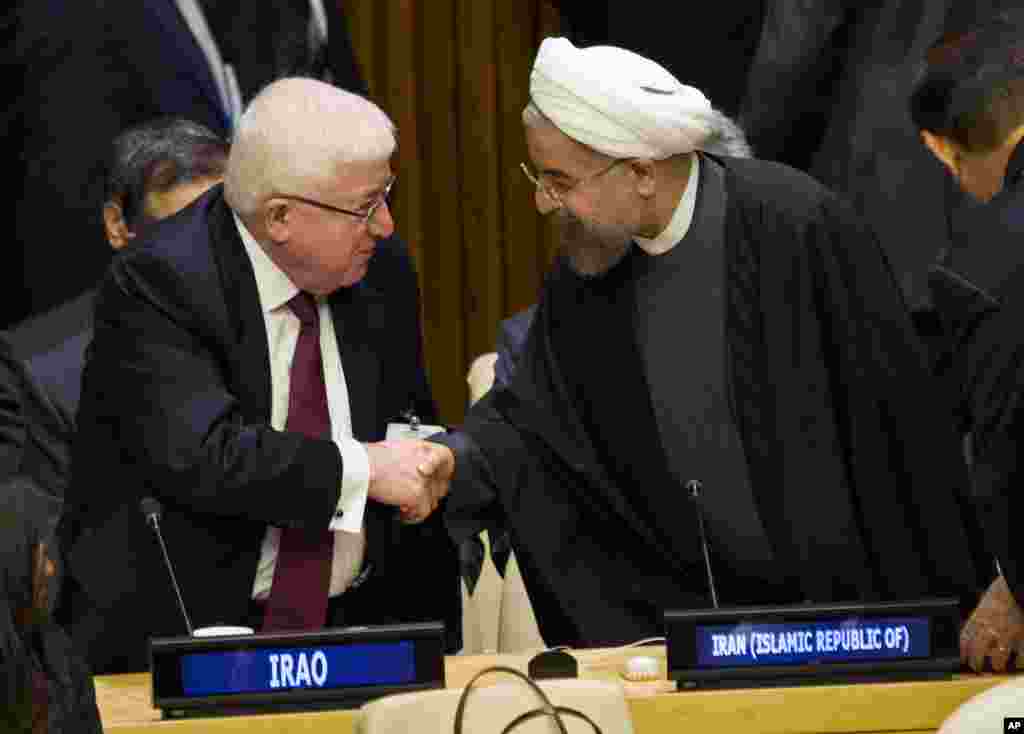 Iraq's President Fuad Masum (left) is greeted by Iranian President Hassan Rouhani as he arrives at the Climate Summit 2014 at U.N. headquarters, Sept. 23, 2014.