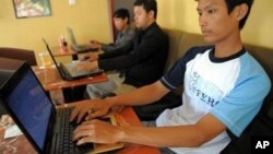 Cambodian men are using internet at a coffee shop in Phnom Penh, file photo.