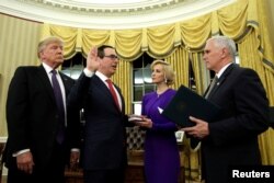 U.S. President Donald Trump, left, watches as Vice President Mike Pence, right, swears in Steve Mnuchin as Treasury Secretary next to his fiancé, Louise Linton, in the Oval Office of the White House in Washington, Feb. 13, 2017.