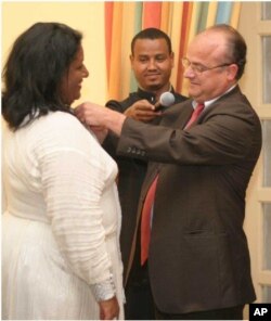 France's Ambassador to Ethiopia awarding Medal to Senedu in Addis Ababa