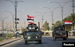 Iraqi security forces advance in military vehicles in Kirkuk, Iraq, Oct. 16, 2017.