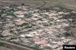 FILE - An aerial view shows burned down villages once inhabited by the Rohingya seen from the Myanmar military helicopters that carried the U.N. envoys to northern Rakhine state, Myanmar, May 1, 2018.