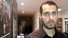 FILE - Abdulrahman Almawwas, co-founder of the Syrian White Helmets voluntary rescue force, is pictured in Paris, Feb. 13, 2018. He said it's hoped that the transitional government "will lead us to a new Syria that all Syrians dream of." 